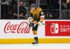 Mitch Marner Point Projections 2026-27: Vegas Golden Knights Fantasy Outlook Mitch Marner celebrates for the Vegas Golden Knights beside Coca-Cola and Nintendo Switch board ads in a 2026-27 fantasy hockey projection.