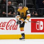 Mitch Marner Point Projections 2026-27: Vegas Golden Knights Fantasy Outlook Mitch Marner celebrates for the Vegas Golden Knights beside Coca-Cola and Nintendo Switch board ads in a 2026-27 fantasy hockey projection.
