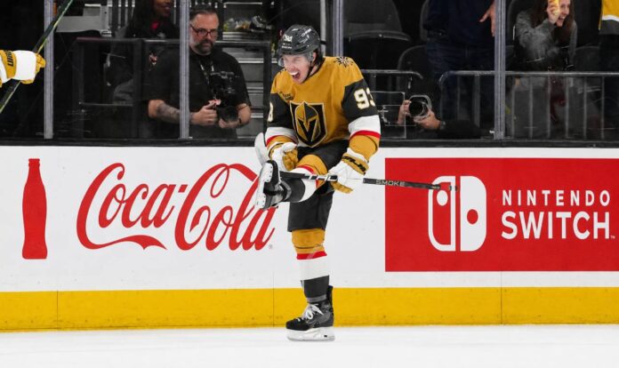 mitch-marner-vegas-golden-knights-fantasy-hockey-projection-2026-27 Mitch Marner celebrates for the Vegas Golden Knights beside Coca-Cola and Nintendo Switch board ads in a 2026-27 fantasy hockey projection.