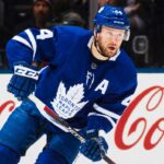 Morgan Rielly’s Four-Team Trade List Leaves the Maple Leafs Facing an Awkward Decision Morgan Rielly skating in a Toronto Maple Leafs home jersey as trade rumours surround his reported four-team destination list.