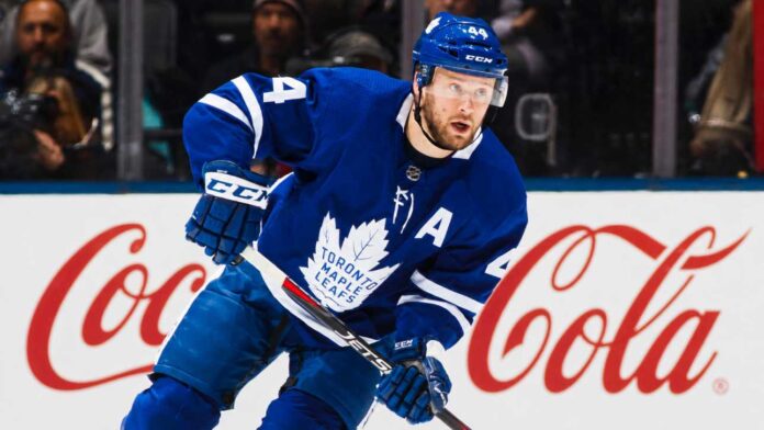 morgan-rielly-maple-leafs-four-team-trade-list Morgan Rielly skating in a Toronto Maple Leafs home jersey as trade rumours surround his reported four-team destination list.