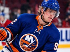 Patrik Laine wearing a New York Islanders home jersey and helmet as he is linked to the team in NHL free agency rumors.