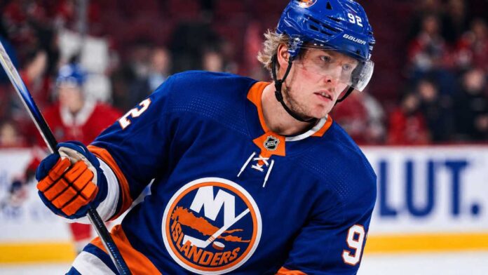 Patrik Laine wearing a New York Islanders home jersey and helmet as he is linked to the team in NHL free agency rumors.