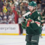 Quinn Hughes in a Minnesota Wild jersey during contract extension rumors involving a potential $17 million to $18 million annual salary
