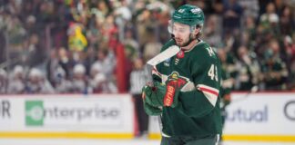 Quinn Hughes in a Minnesota Wild jersey during contract extension rumors involving a potential $17 million to $18 million annual salary
