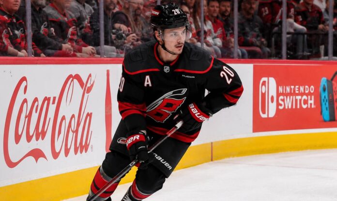 sebastian-aho-carolina-hurricanes-fantasy-hockey-projection-2026-27 Sebastian Aho skating for the Carolina Hurricanes as a left-shot beside Coca-Cola and Nintendo Switch ads in a 2026-27 fantasy hockey projection