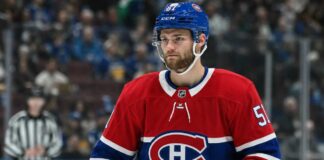 Shane Wright wearing a Montreal Canadiens home jersey amid trade rumors linking the Seattle Kraken center to Montreal