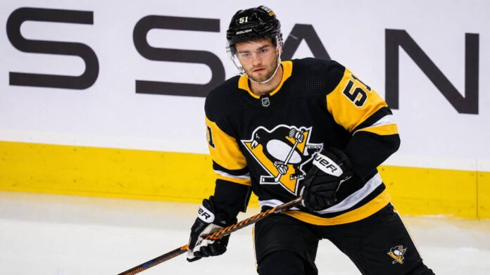 shane-wright-pittsburgh-penguins-trade-rumor Shane Wright wearing a Pittsburgh Penguins home jersey amid NHL trade rumors involving the Seattle Kraken