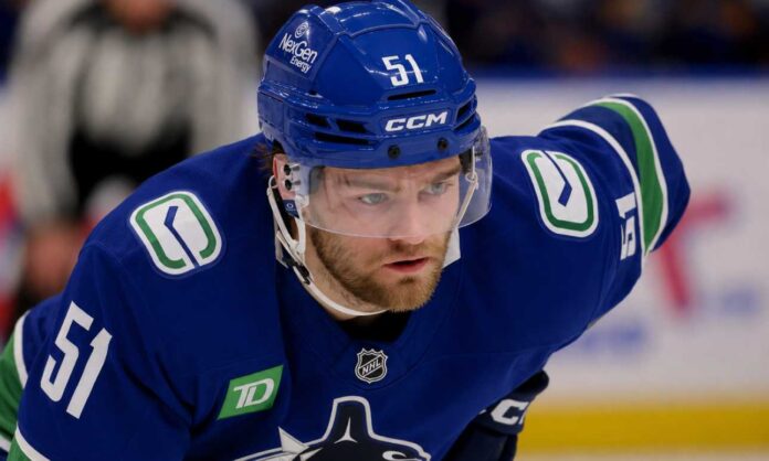 shane-wright-vancouver-canucks-trade-rumors-2026 Shane Wright wearing a Vancouver Canucks home jersey amid trade rumors involving the Seattle Kraken.