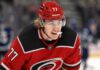 Will the Carolina Hurricanes Offer Sheet Simon Edvinsson? Simon Edvinsson wearing a Carolina Hurricanes home jersey amid NHL offer-sheet rumors involving the Detroit Red Wings