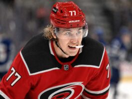 Will the Carolina Hurricanes Offer Sheet Simon Edvinsson? Simon Edvinsson wearing a Carolina Hurricanes home jersey amid NHL offer-sheet rumors involving the Detroit Red Wings