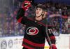 Simon Edvinsson wearing a Carolina Hurricanes home jersey amid offer-sheet rumors involving the Detroit Red Wings.