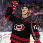 Could the Carolina Hurricanes Force Detroit’s Hand With a Simon Edvinsson Offer Sheet? Simon Edvinsson wearing a Carolina Hurricanes home jersey amid offer-sheet rumors involving the Detroit Red Wings.