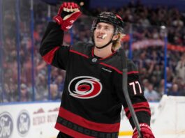 Could the Carolina Hurricanes Force Detroit’s Hand With a Simon Edvinsson Offer Sheet? Simon Edvinsson wearing a Carolina Hurricanes home jersey amid offer-sheet rumors involving the Detroit Red Wings.