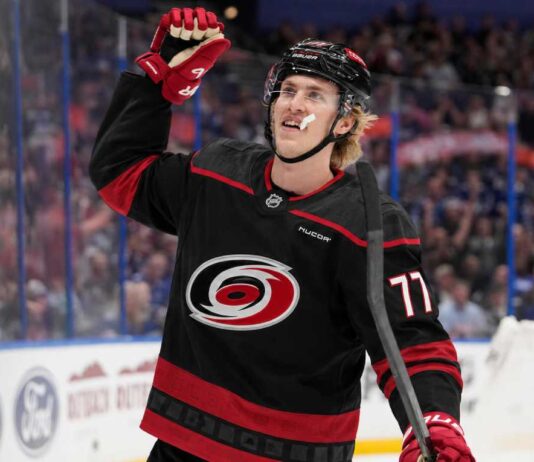 Could the Carolina Hurricanes Force Detroit’s Hand With a Simon Edvinsson Offer Sheet? Simon Edvinsson wearing a Carolina Hurricanes home jersey amid offer-sheet rumors involving the Detroit Red Wings.