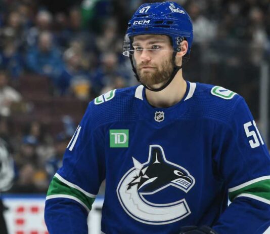 Vancouver Canucks Interested in Shane Wright, but Seattle Kraken Set Enormous Trade Price Shane Wright wearing a Vancouver Canucks home jersey amid trade rumors involving the Seattle Kraken, Zeev Buium and Tom Willander.