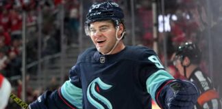 Concept image for Alex DeBrincat trade rumours showing a hockey player in a Seattle Kraken home jersey and helmet