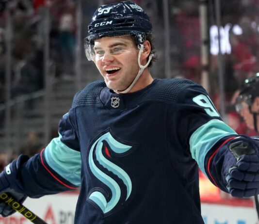 Concept image for Alex DeBrincat trade rumours showing a hockey player in a Seattle Kraken home jersey and helmet