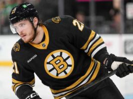 Alexander Nikishin in a Boston Bruins home jersey amid NHL trade rumors involving the Carolina Hurricanes