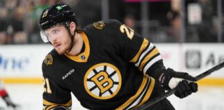 Alexander Nikishin in a Boston Bruins home jersey amid NHL trade rumors involving the Carolina Hurricanes