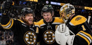 David Pastrnak, Charlie McAvoy and Jeremy Swayman celebrate a Boston Bruins win last season.