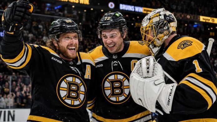 boston-bruins-2026-27-season-preview-predictions David Pastrnak, Charlie McAvoy and Jeremy Swayman celebrate a Boston Bruins win last season.