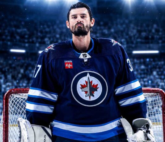 Connor Hellebuyck in a Winnipeg Jets jersey amid Buffalo Sabres trade rumors ahead of NHL training camp