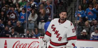 Connor Hellebuyck in a Carolina Hurricanes away jersey amid Winnipeg Jets trade rumors after his public trade request