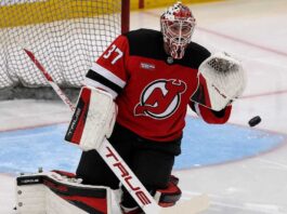 Connor Hellebuyck in a New Jersey Devils home jersey as trade rumors link the Winnipeg Jets goalie to a potential blockbuster move to New Jersey
