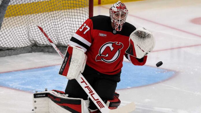 connor-hellebuyck-new-jersey-devils-trade-rumors Connor Hellebuyck in a New Jersey Devils home jersey as trade rumors link the Winnipeg Jets goalie to a potential blockbuster move to New Jersey