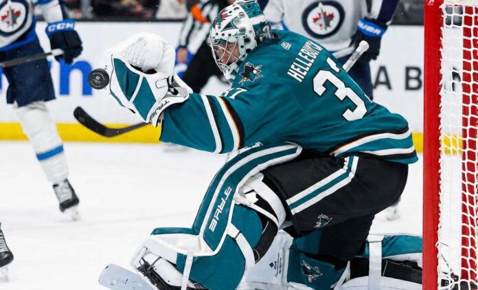 Connor Hellebuyck in a San Jose Sharks home uniform amid NHL trade rumors involving the Winnipeg Jets