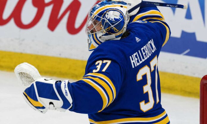 connor-hellebuyck-trade-rumors-buffalo-sabres-jets Connor Hellebuyck pictured in a Buffalo Sabres home jersey and goalie equipment amid trade rumors linking the Winnipeg Jets star to Buffalo.