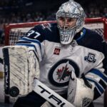 Connor Hellebuyck Trade Rumors: Could a Training Camp Holdout Force the Jets Into a Blockbuster? Connor Hellebuyck in a Winnipeg Jets uniform as NHL trade rumors grow over a possible training camp holdout and blockbuster trade.