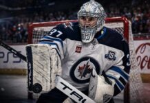 Connor Hellebuyck in a Winnipeg Jets uniform as NHL trade rumors grow over a possible training camp holdout and blockbuster trade.