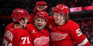 Dylan Larkin, Alex DeBrincat and Moritz Seider celebrate a Detroit Red Wings win ahead of the 2026-27 NHL season.