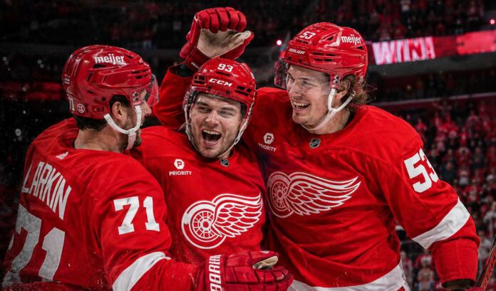 detroit-red-wings-2026-27-season-preview-predictions Dylan Larkin, Alex DeBrincat and Moritz Seider celebrate a Detroit Red Wings win ahead of the 2026-27 NHL season.