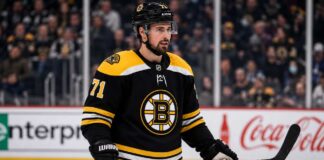 Dylan Larkin in a Boston Bruins jersey amid NHL trade rumors involving the Detroit Red Wings