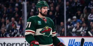 Dylan Larkin in a Minnesota Wild home jersey amid NHL trade rumors linking the Detroit Red Wings captain to Minnesota