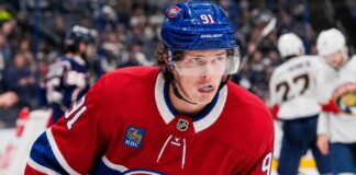 Kent Johnson wearing a Montreal Canadiens home jersey and helmet amid trade rumors linking him to the Canadiens