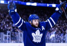 Morgan Rielly celebrates in a Toronto Maple Leafs jersey amid NHL trade rumors about his future in Toronto.