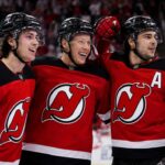 Jack Hughes, Jesper Bratt and Nico Hischier celebrate a New Jersey Devils win ahead of the 2026-27 NHL season.