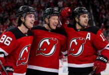 Jack Hughes, Jesper Bratt and Nico Hischier celebrate a New Jersey Devils win ahead of the 2026-27 NHL season.