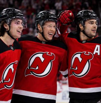 Jack Hughes, Jesper Bratt and Nico Hischier celebrate a New Jersey Devils win ahead of the 2026-27 NHL season.