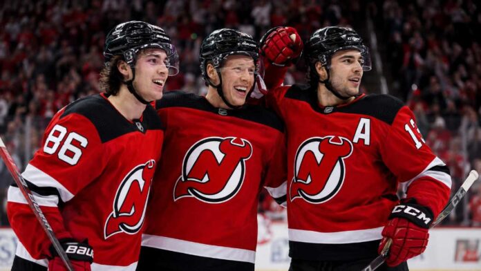 Jack Hughes, Jesper Bratt and Nico Hischier celebrate a New Jersey Devils win ahead of the 2026-27 NHL season.
