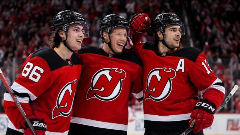 Jack Hughes, Jesper Bratt and Nico Hischier celebrate a New Jersey Devils win ahead of the 2026-27 NHL season.