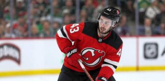 Quinn Hughes wearing a New Jersey Devils home jersey in a concept image tied to his potential 2027 NHL free-agent move from the Minnesota Wild