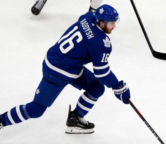 Maple Leafs Trade Rumors: Could Taylor Raddysh Leave Rangers to Join His Brother in Toronto? Taylor Raddysh in a Toronto Maple Leafs home jersey amid NHL trade rumors linking the New York Rangers winger to Toronto.