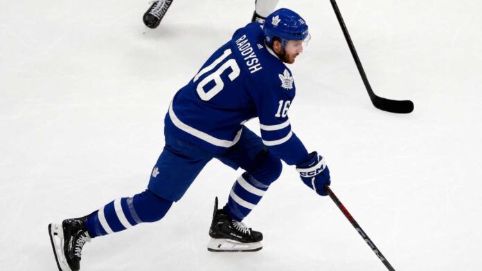 taylor-raddysh-maple-leafs-trade-rumors-rangers Taylor Raddysh in a Toronto Maple Leafs home jersey amid NHL trade rumors linking the New York Rangers winger to Toronto.