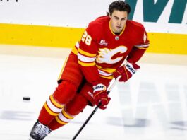 Is Zach Whitecloud on the Trade Block? Calgary Flames Face an Interesting Decision Calgary Flames defenseman Zach Whitecloud skates in a red Flames jersey amid NHL trade rumors linking him to a possible move.