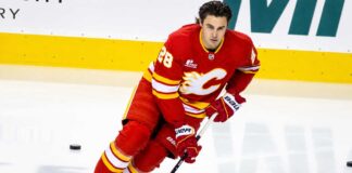 Is Zach Whitecloud on the Trade Block? Calgary Flames Face an Interesting Decision Calgary Flames defenseman Zach Whitecloud skates in a red Flames jersey amid NHL trade rumors linking him to a possible move.